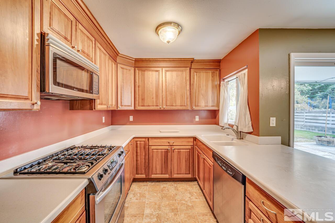 1950 Wren Street Reno, NV 89509 - Photo 6 of 24 a kitchen with a sink stove and cabinets