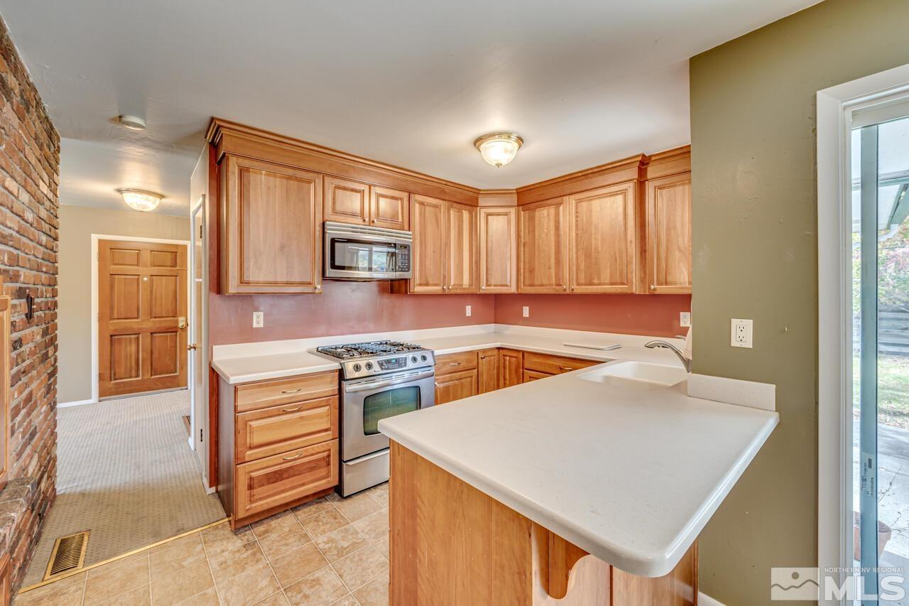 1950 Wren Street Reno, NV 89509 - Photo 7 of 24 a kitchen with a stove a sink and a refrigerator