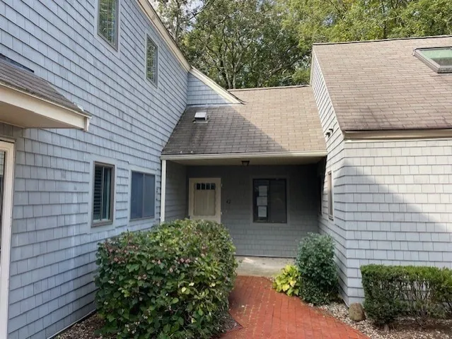 a view of a house with brick walls and potted plants
