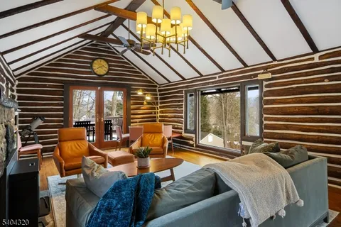 a living room with furniture and floor to ceiling windows