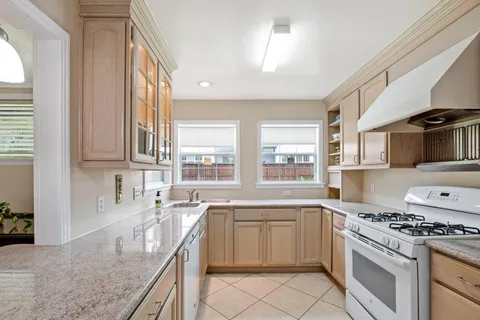 a kitchen with granite countertop a sink stainless steel appliances and cabinets