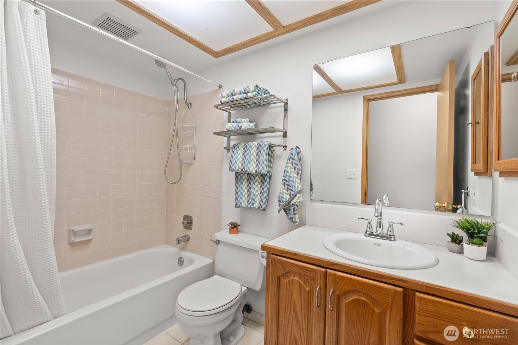 4505 Southwest 317th Place Federal Way, WA 98023 - Photo 23 of 31 a bathroom with a granite countertop sink a toilet a mirror a vanity a bathtub and shower