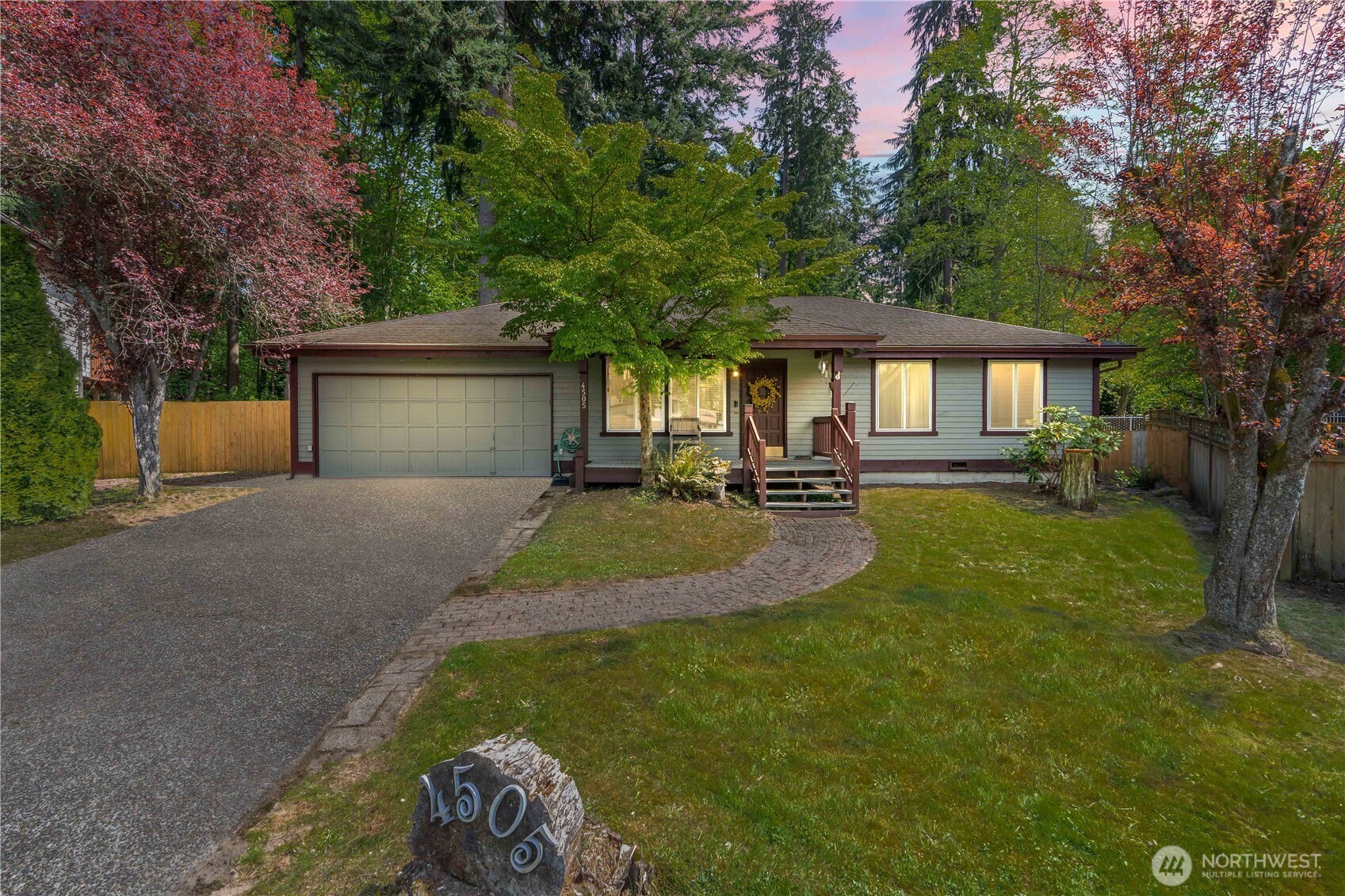 4505 Southwest 317th Place Federal Way, WA 98023 - Photo 27 of 31 a front view of a house with a yard garage and outdoor seating