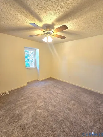 a view of a big room with windows and chandelier