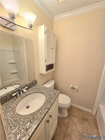 a bathroom with a granite countertop sink toilet and a mirror