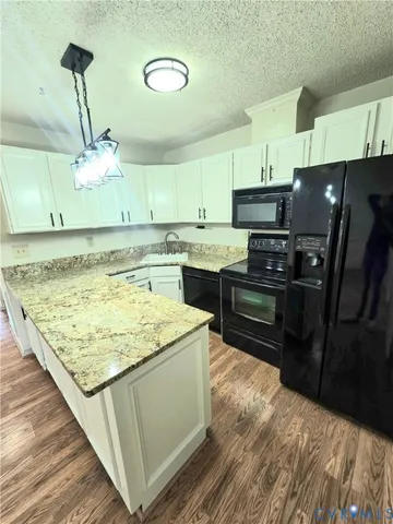 a kitchen with kitchen island a sink stainless steel appliances and cabinets