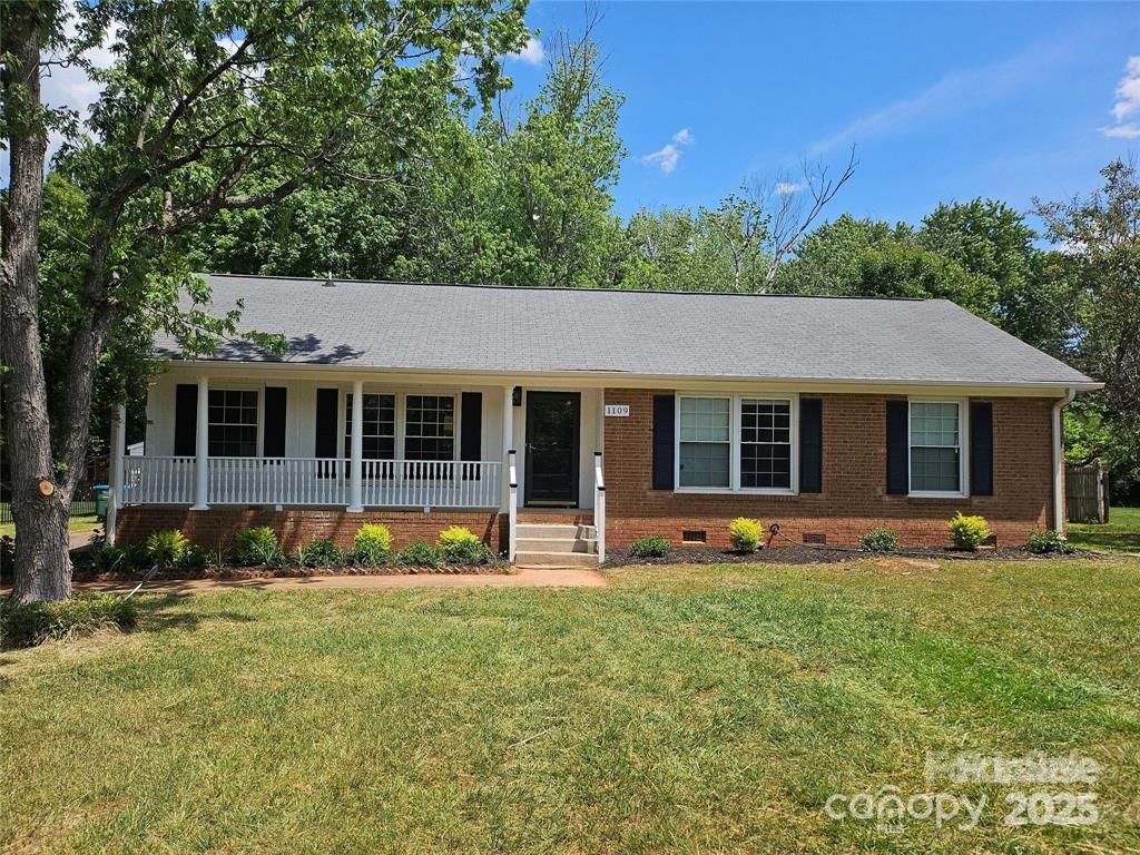 1109 Reid Harkey Road Matthews, NC 28105 - Photo 1 of 13 a front view of a house with a yard