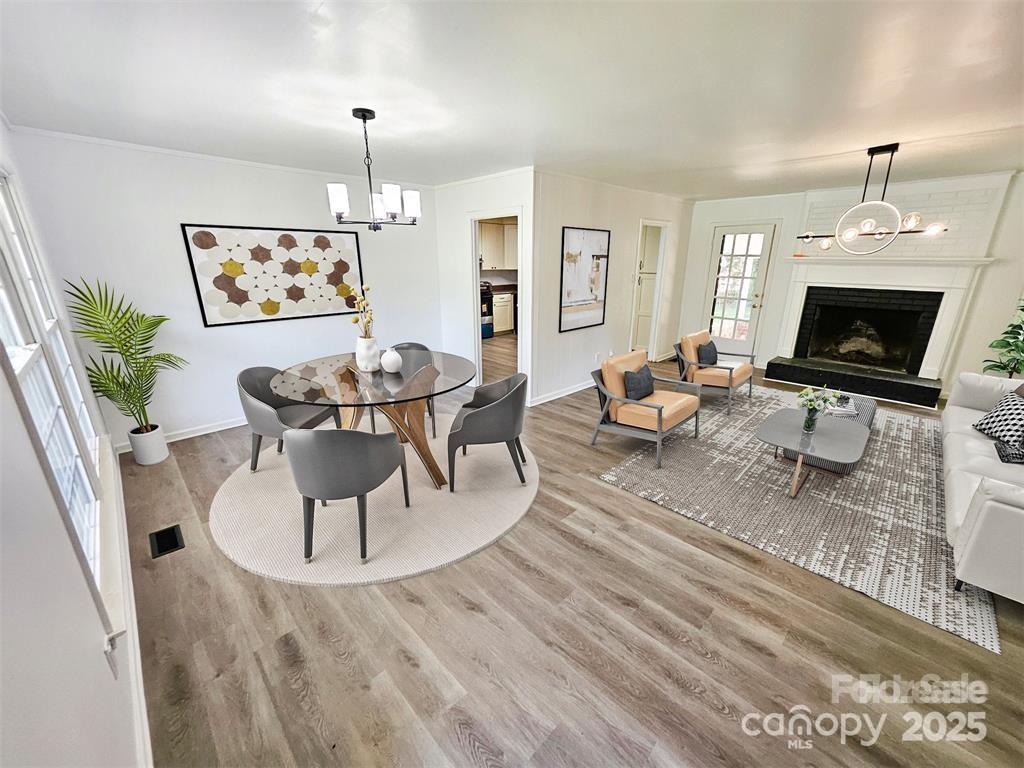 1109 Reid Harkey Road Matthews, NC 28105 - Photo 4 of 13 a living room with furniture a fireplace and a chandelier