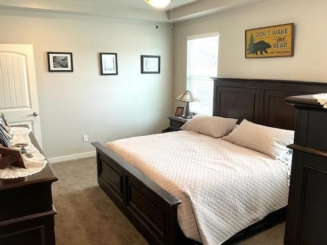a bathroom with a granite countertop sink a mirror and shower