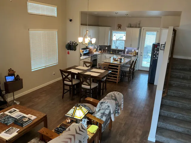 a dining room with furniture and wooden floor