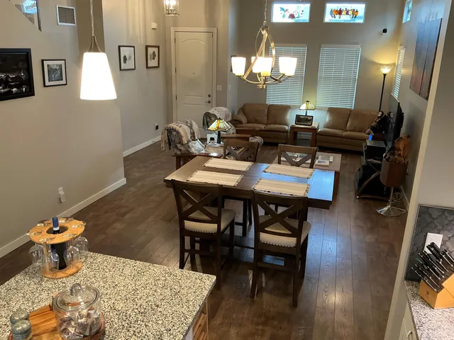 a dining room with furniture and wooden floor