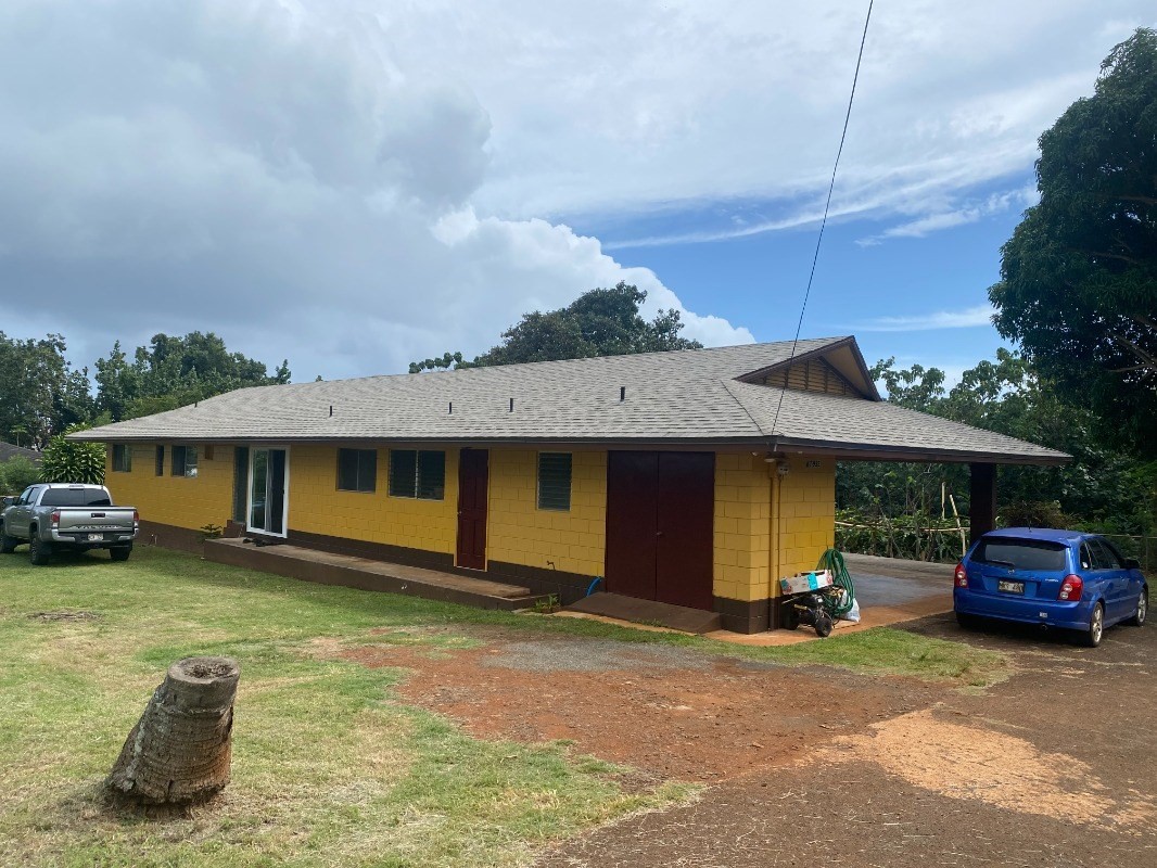 4793 Nonou Road Kapaa, HI 96746 - Photo 1 of 12 a front view of a house with a garden and parking