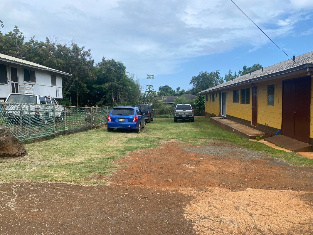 4793 Nonou Road Kapaa, HI 96746 - Photo 12 of 12 a car parked in front of a house with a yard