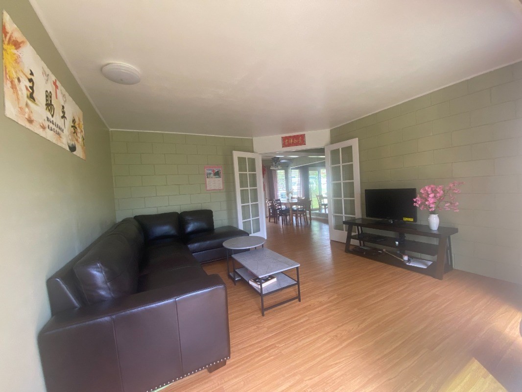 4793 Nonou Road Kapaa, HI 96746 - Photo 2 of 12 a living room with furniture and a flat screen tv