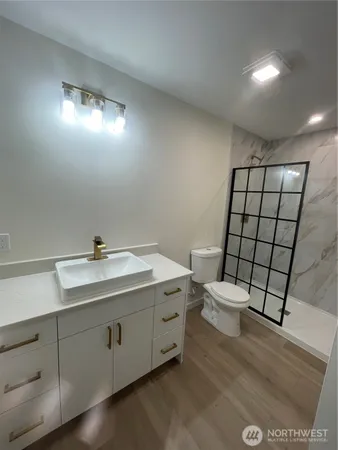 a bathroom with a sink toilet and mirror