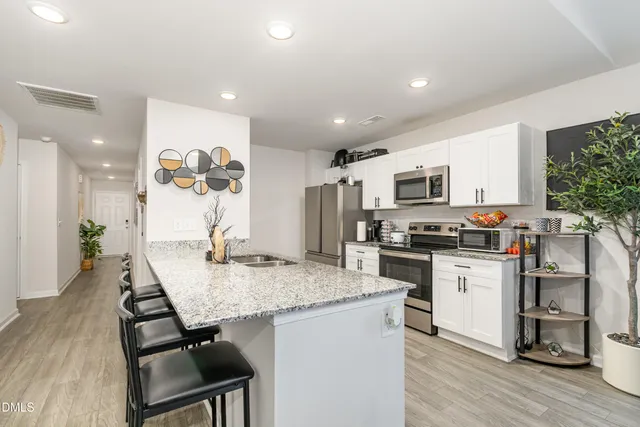 a view of a dining room with furniture and wooden floor