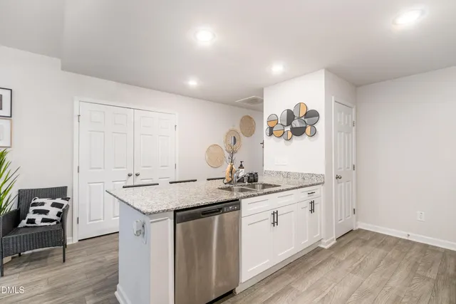 a kitchen with sink cabinets and wooden floor