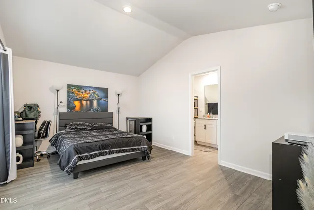a bedroom with a bed and a tv on table