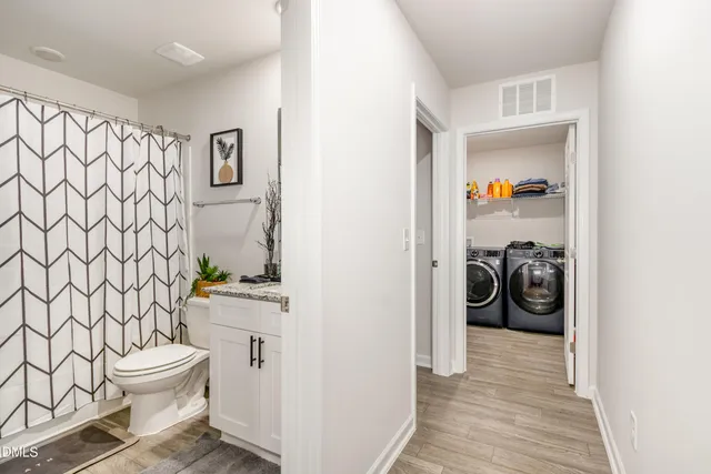 a bathroom with a toilet and a shower curtain