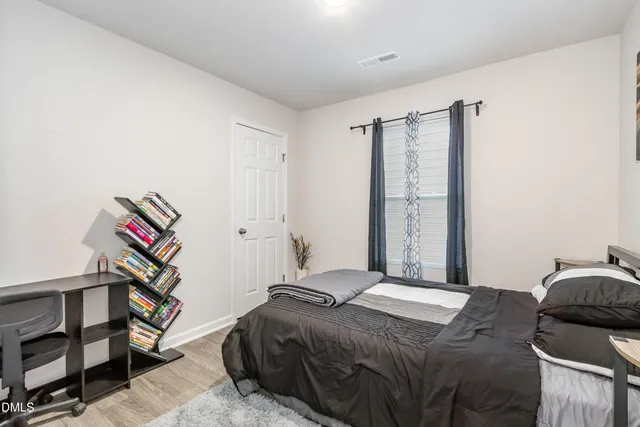 a bedroom with a bed and a closet