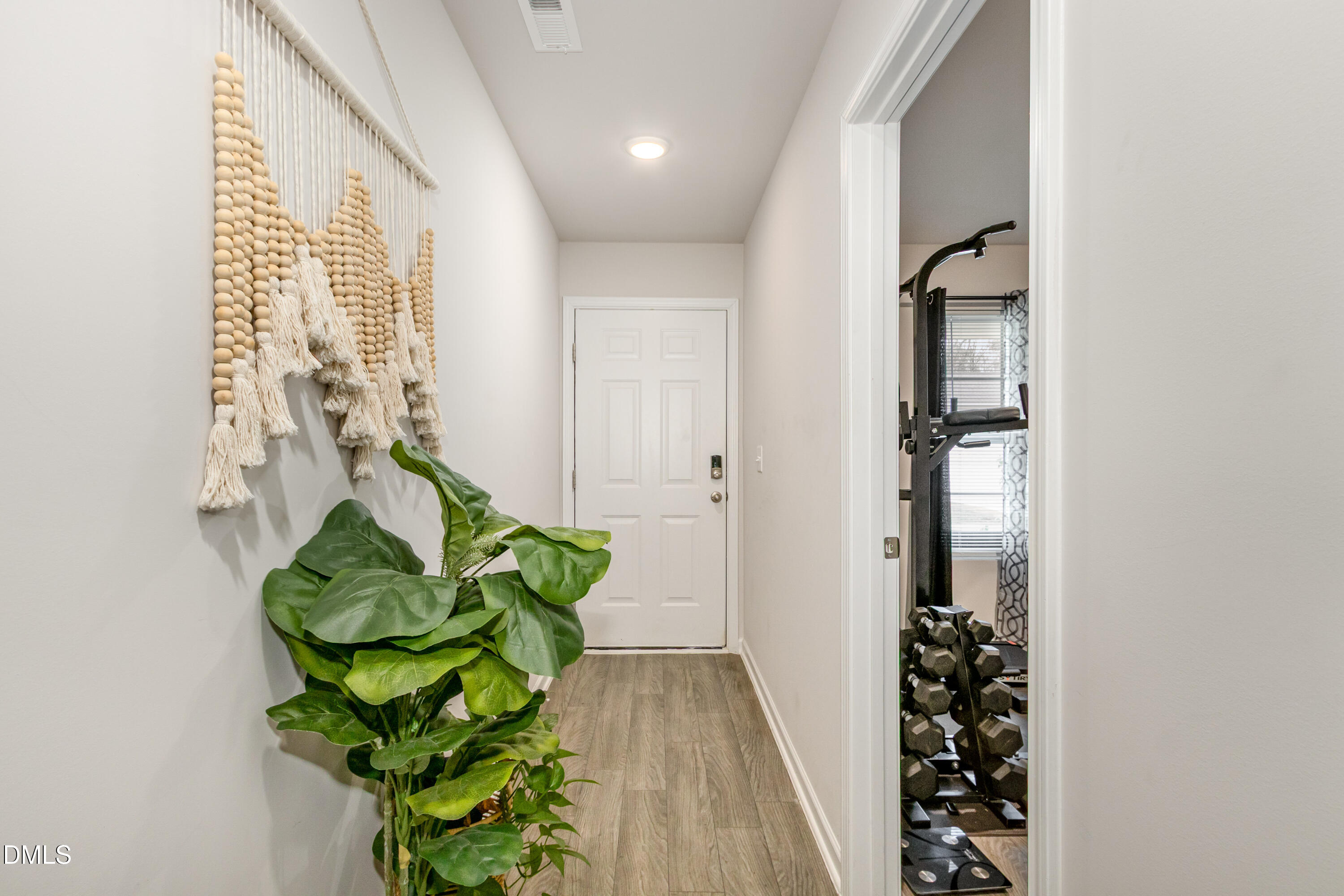196 Keith Place Roxboro, NC 27573 - Photo 5 of 28 a view of a hallway with wooden floor and a potted plant