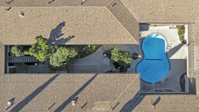 a view of a roof deck with chairs and a yard
