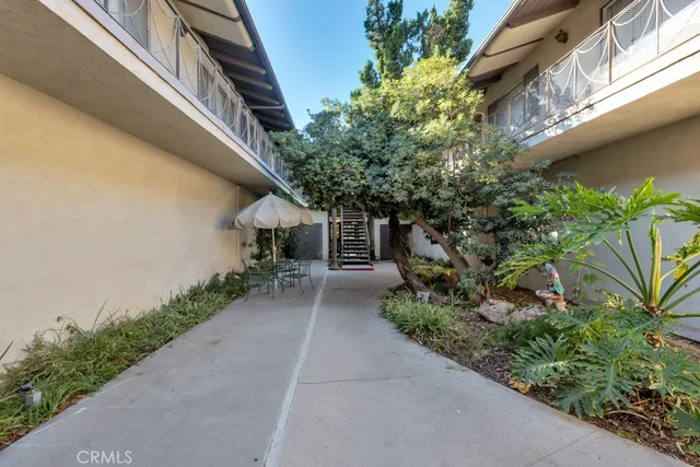 a backyard of a house with table and chairs