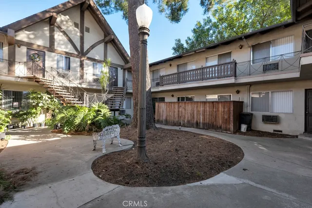 a view of a house with a small yard and wooden fence