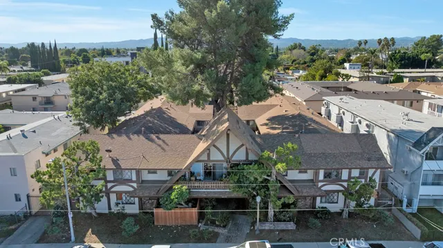 an aerial view of multiple houses with yard