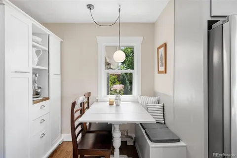 a view of a dining room that has a table and chairs
