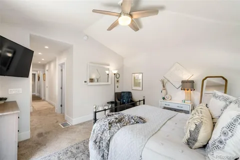 a bedroom with a bed and a television