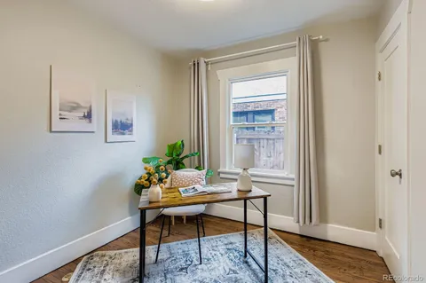a workspace room with furniture and wooden floor