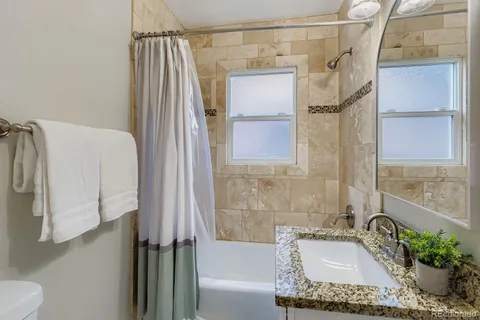 a bathroom with a tub and shower