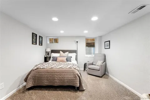 a bedroom with a bed and a couch