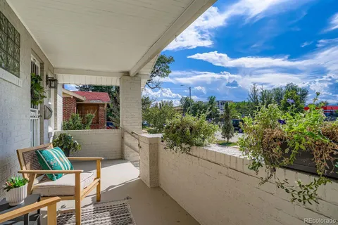 a balcony with table and chairs