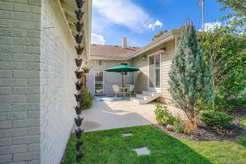 a view of a patio with table and chairs and potted plants