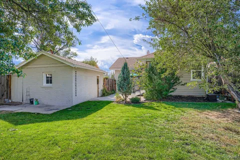 a view of a house with a yard and sitting area