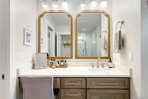 a bathroom with a double vanity sink and a mirror