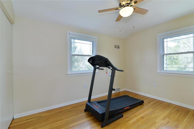 2595 Cole Road Wexford, PA 15090 - Photo 20 of 25 Bedroom 2 with all natural lighting. NEW matching stainless ceiling fan/light, and radiant hardwood floors.