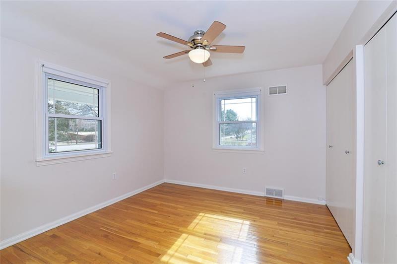 2595 Cole Road Wexford, PA 15090 - Photo 21 of 25 LARGE bedroom 3 with two large dual door closets with lots of storage space. Natural lighting, NEW matching fan/light, and original hardwood flooring.