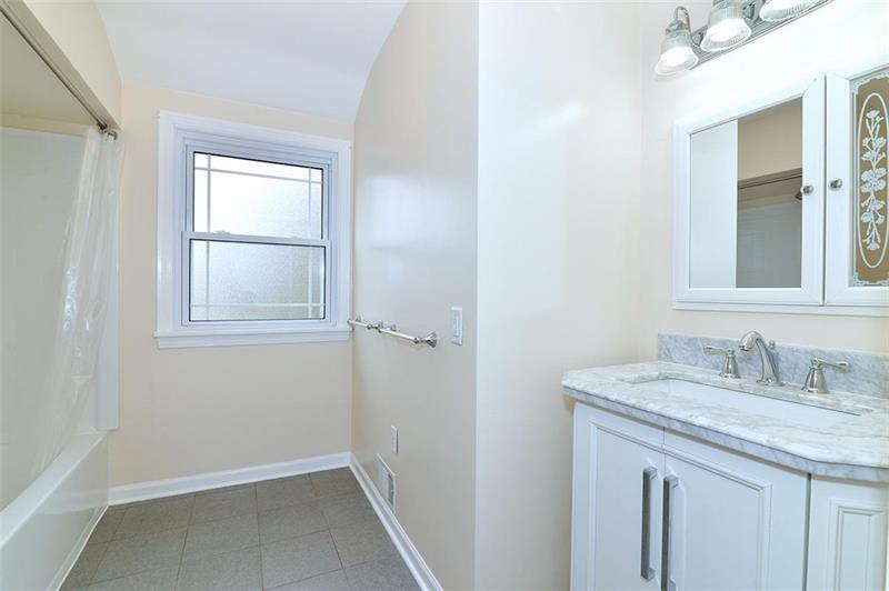 2595 Cole Road Wexford, PA 15090 - Photo 23 of 25 Upgraded upper full bath with ceramic flooring, updated granite vanity and stainless fixtures, and lighting.
