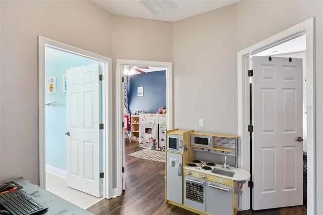 a view of kitchen with wooden floor and electronic appliances