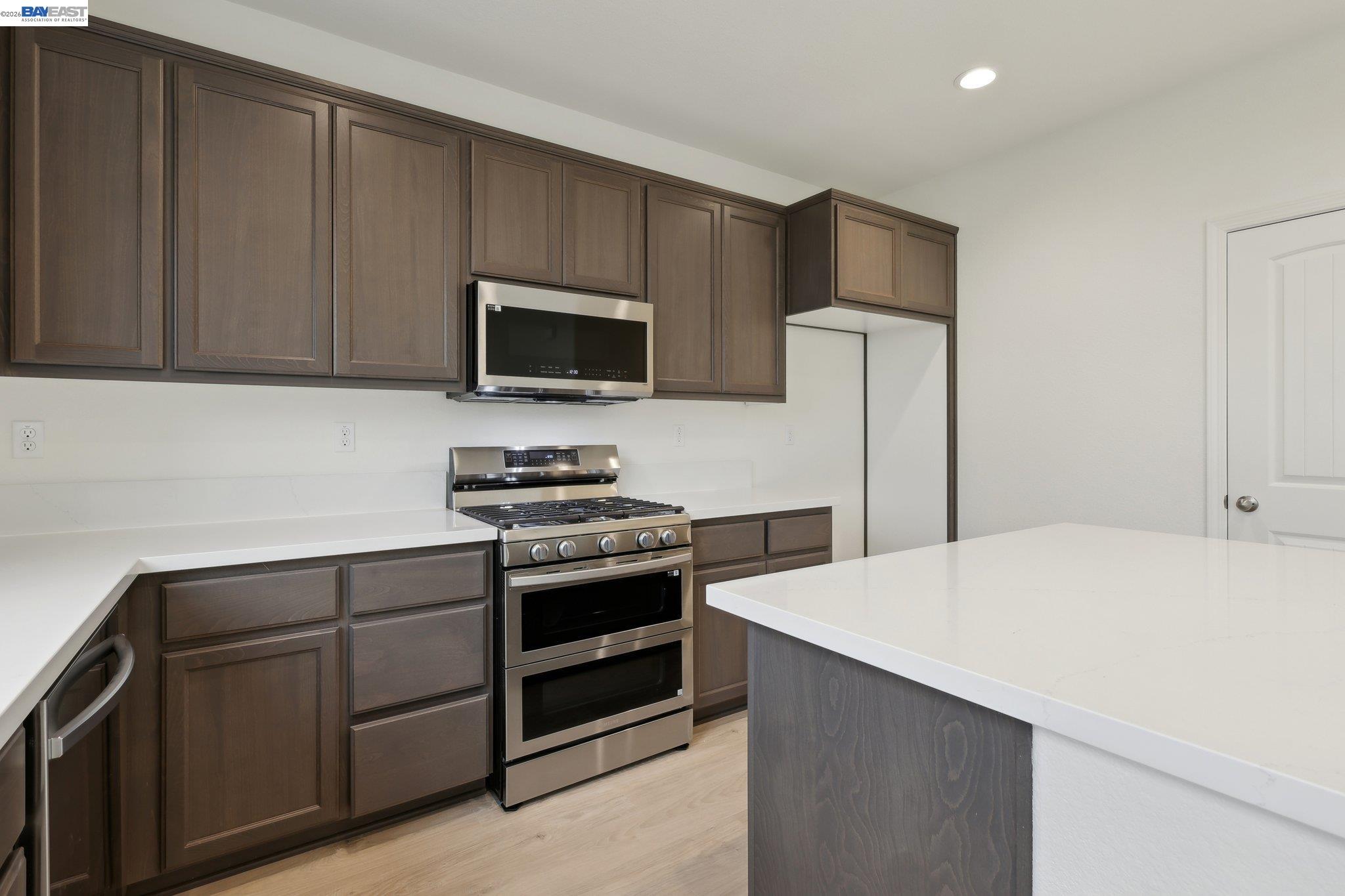 230 Mindy Way Pittsburg, CA 94565 - Photo 12 of 33 a kitchen with kitchen island a sink appliances and cabinets