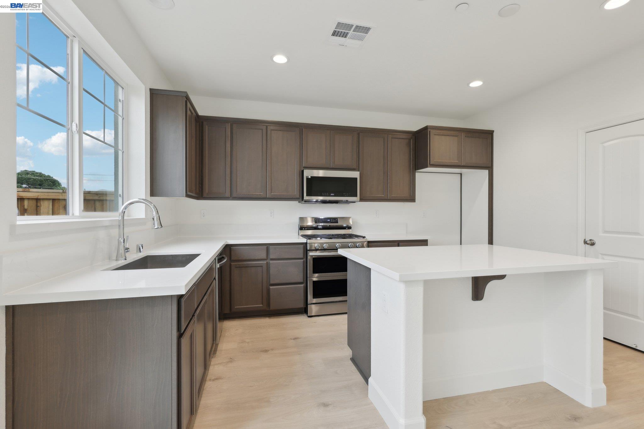 230 Mindy Way Pittsburg, CA 94565 - Photo 14 of 33 a kitchen with stainless steel appliances granite countertop a sink stove oven and refrigerator