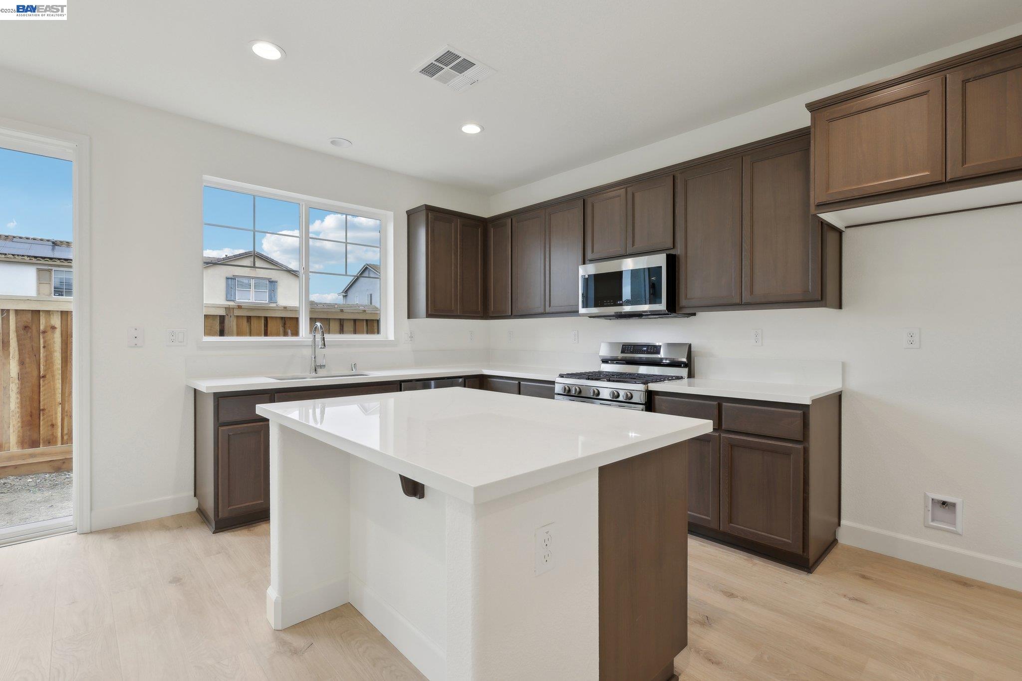 230 Mindy Way Pittsburg, CA 94565 - Photo 9 of 33 a kitchen with stainless steel appliances granite countertop a sink stove and microwave