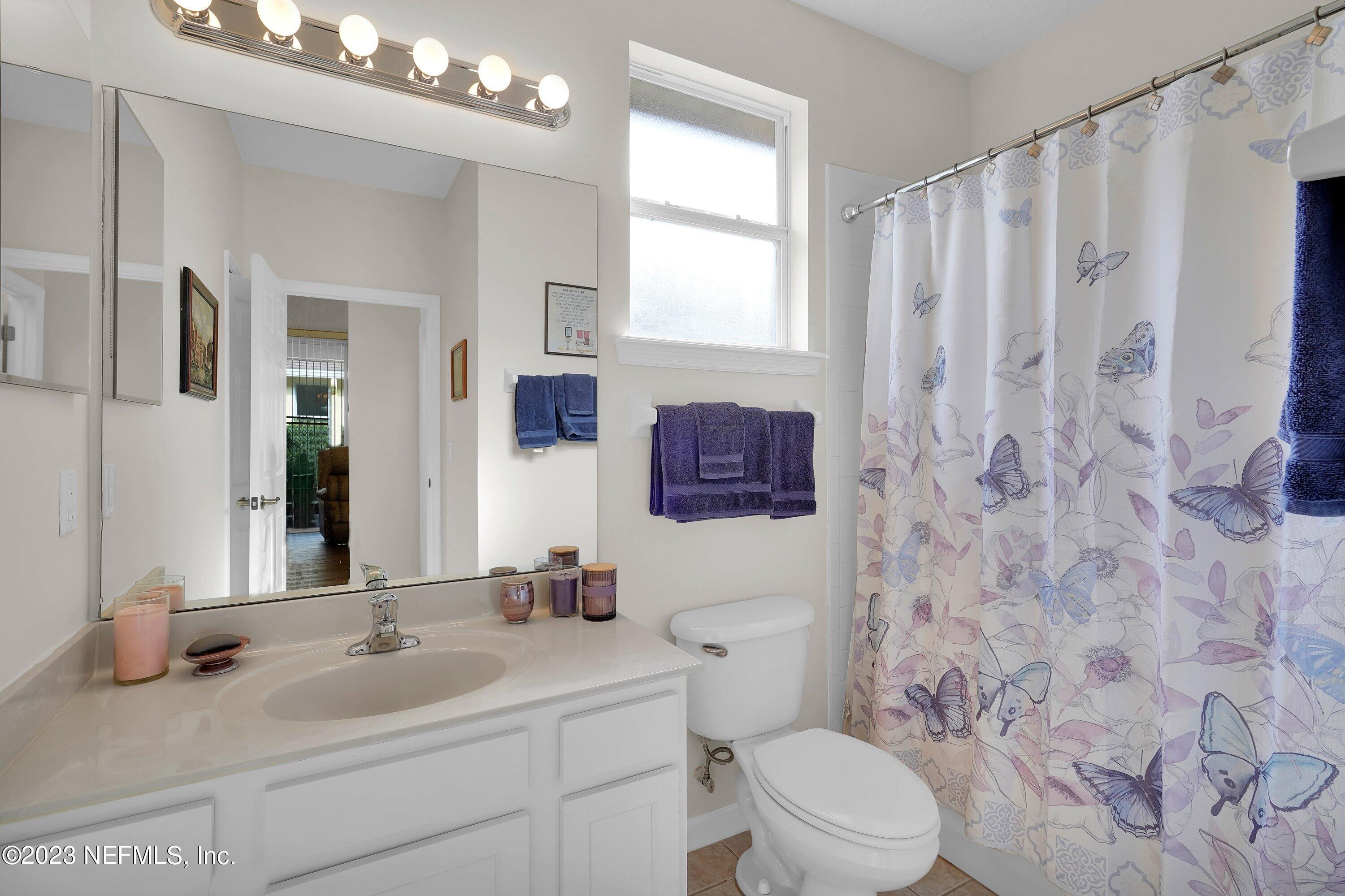 746 Copperhead Circle St. Augustine, FL 32092 - Photo 15 of 40 a bathroom with a toilet sink and mirror