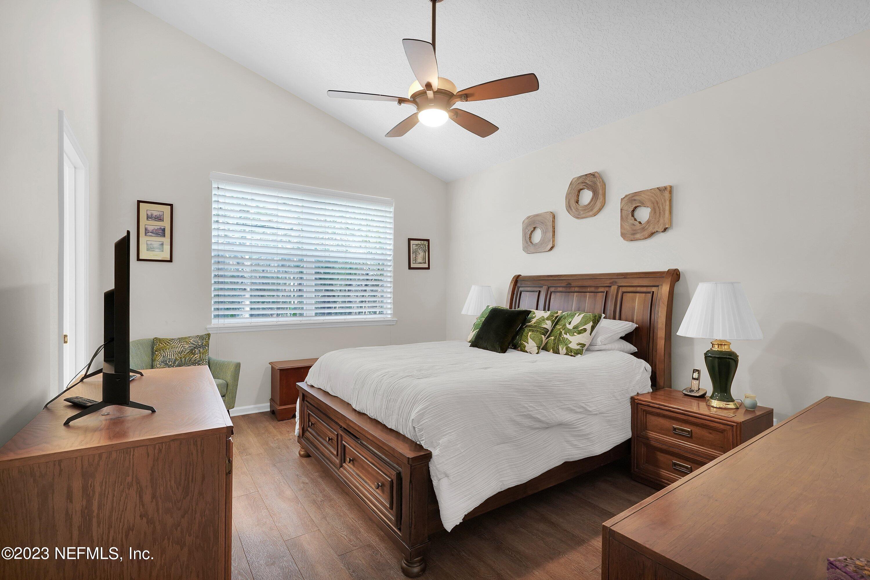 746 Copperhead Circle St. Augustine, FL 32092 - Photo 17 of 40 a bedroom with a bed and a table with a mirror