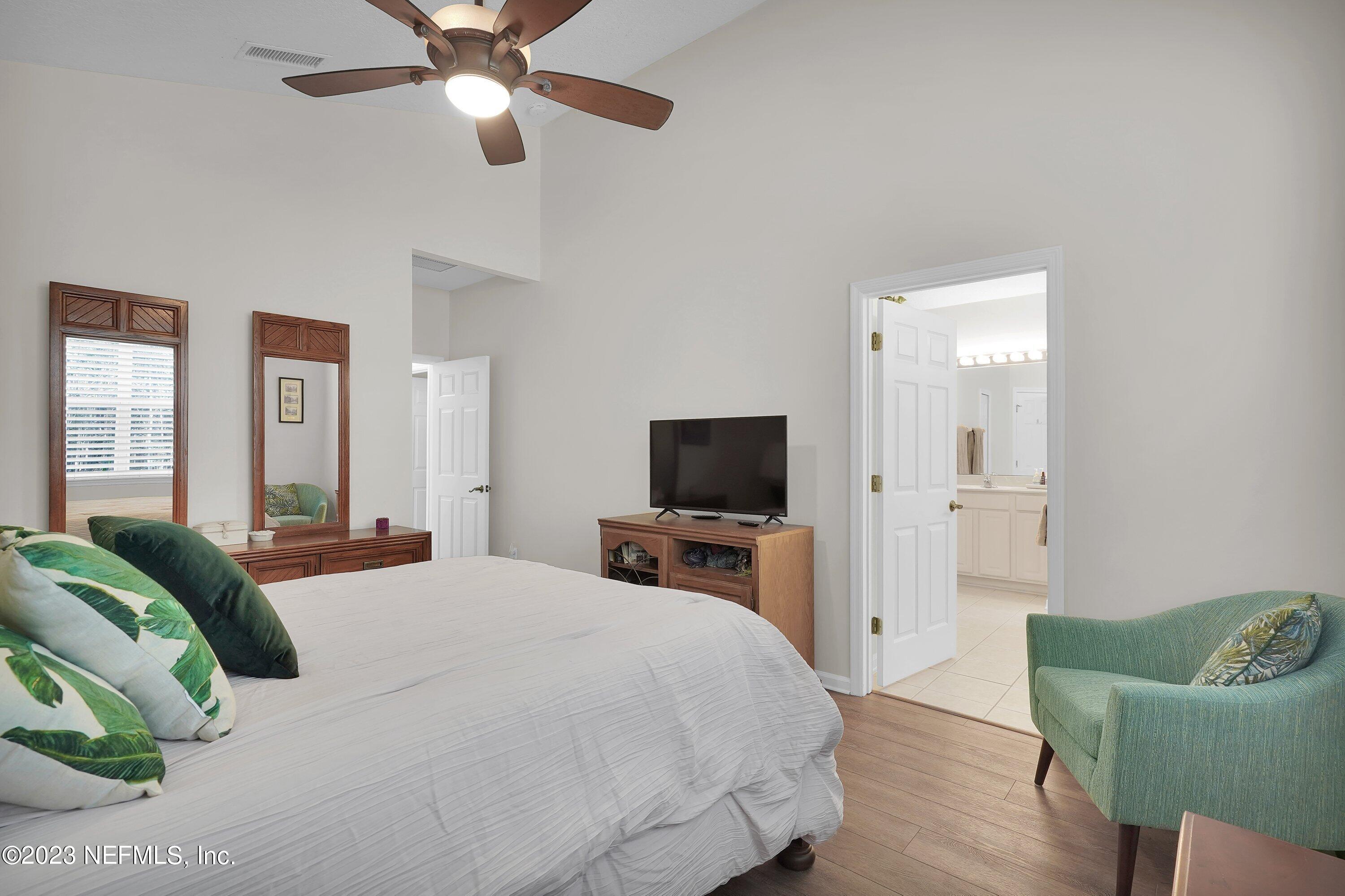 746 Copperhead Circle St. Augustine, FL 32092 - Photo 18 of 40 a bedroom with a bed and a flat screen tv