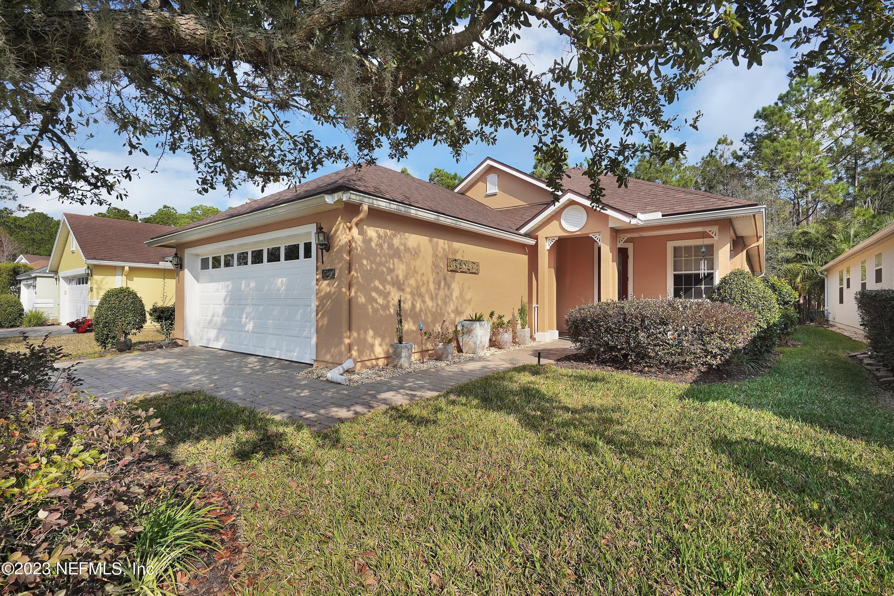 746 Copperhead Circle St. Augustine, FL 32092 - Photo 2 of 40 a front view of a house with a yard and garage