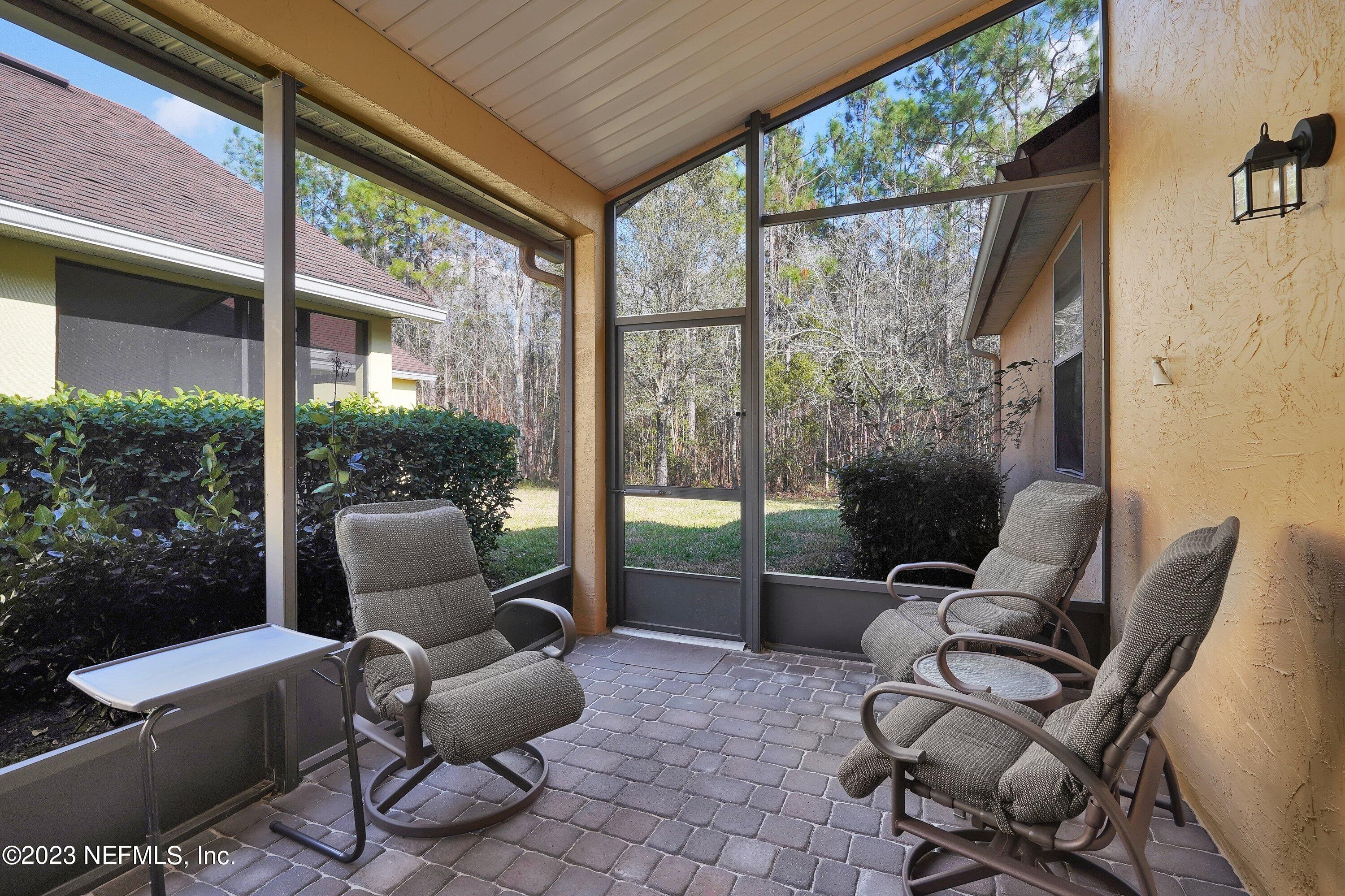 746 Copperhead Circle St. Augustine, FL 32092 - Photo 21 of 40 a patio with yard glass table and chairs
